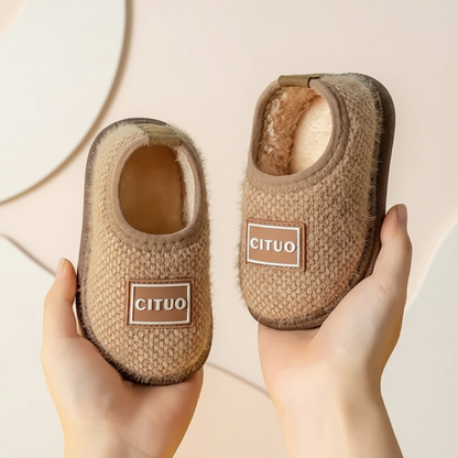 Comfortable children's suede indoor shoes with non-slip traction, winter-ready.
