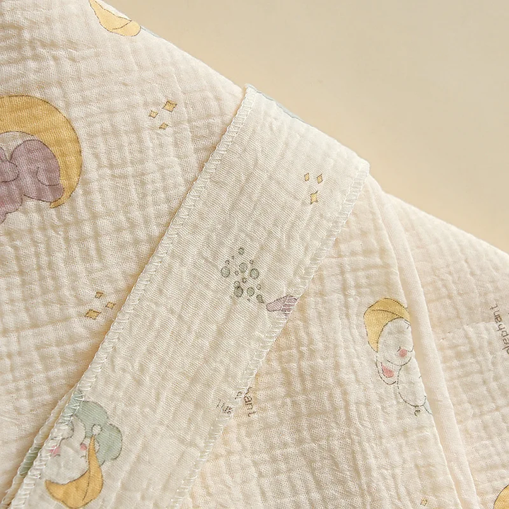 Set of two baby swaddle blankets, one blue and one green, made from breathable cotton.