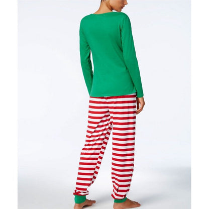 Parents and baby wearing coordinating Christmas themed pajamas, celebrating the holidays.