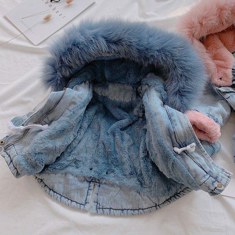 Stylish toddler denim jacket featuring a cozy faux fur hood & warm plush lining for winter.