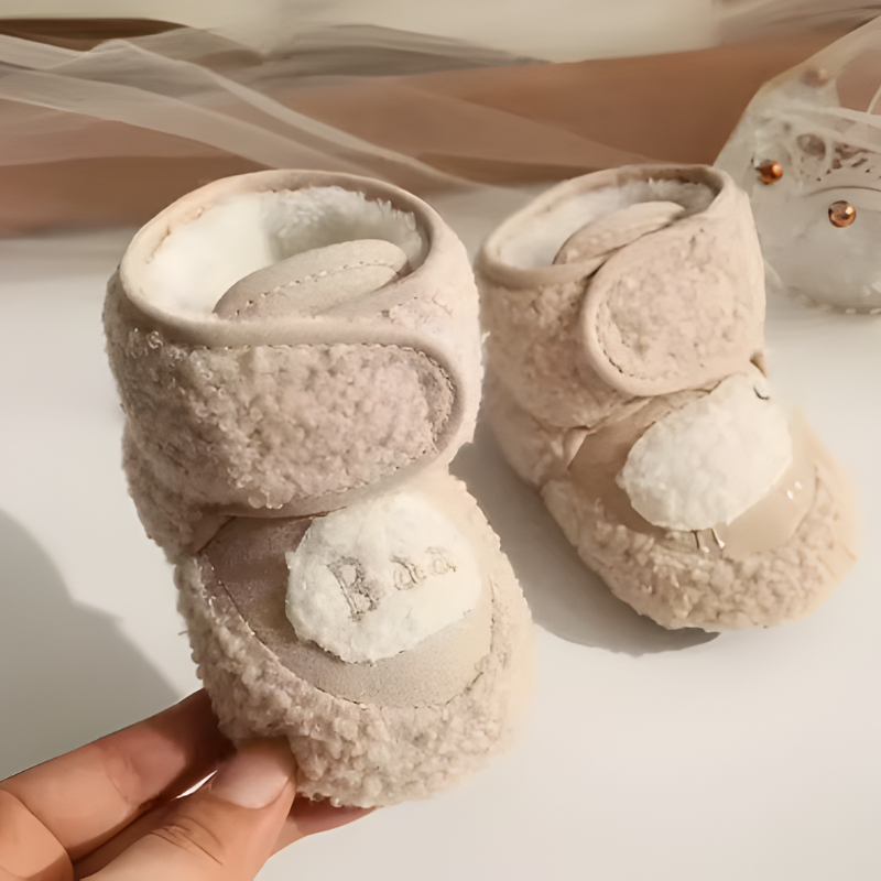 Newborn fleece crib shoes with anti-slip sole, ensuring warmth and safety for little ones.