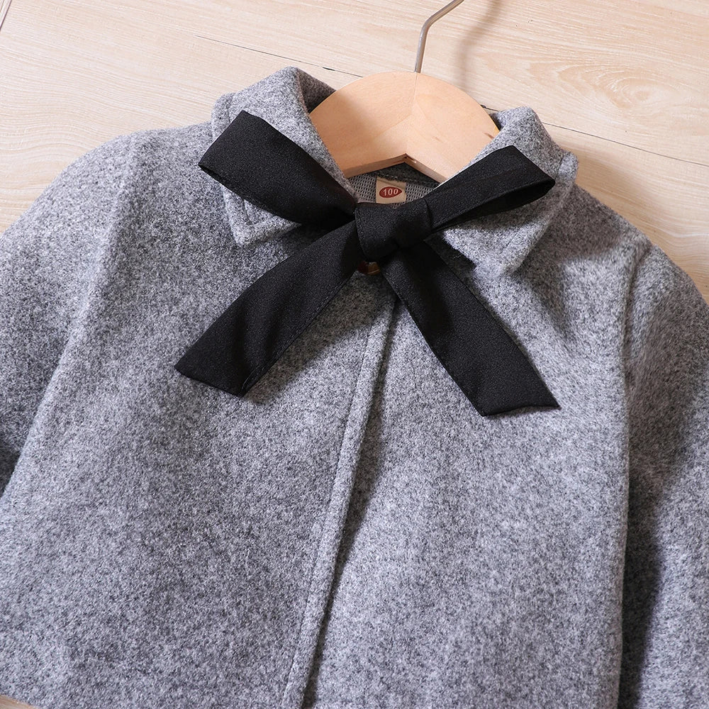 Warm girls' fleece coat with bow detail, paired with a tank top dress & beret for winter.