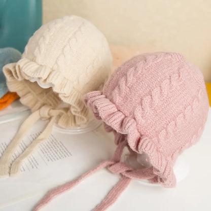 Cute hooded woolen hat for baby girls with ear flaps, ideal for winter warmth & comfort