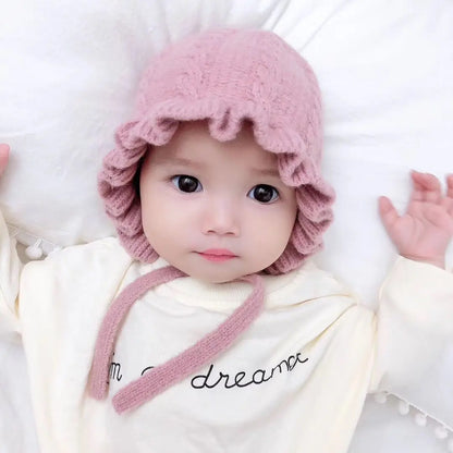 Pink hooded baby girl's hat, soft cotton blend, keeps newborns cozy in cold weather