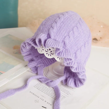 Warm hooded winter hat for infant girls, featuring braided ties & a plush lining