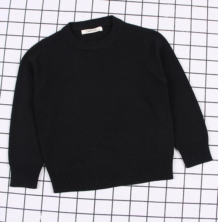 Close-up of the ribbed cuffs and hem on a practical kids cable knit pullover sweater, 100% cozy.