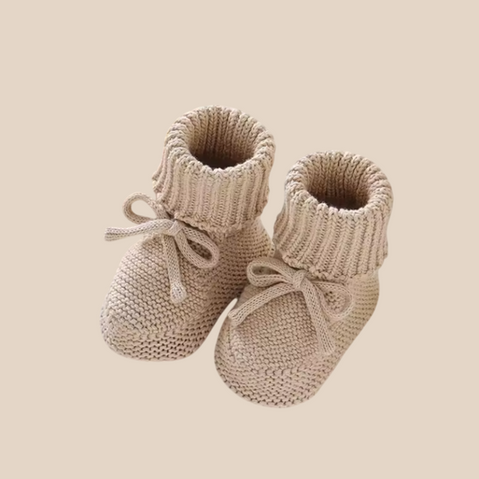 Cozy knitted baby booties in a warm, soft cotton wool blend, perfect for newborns.