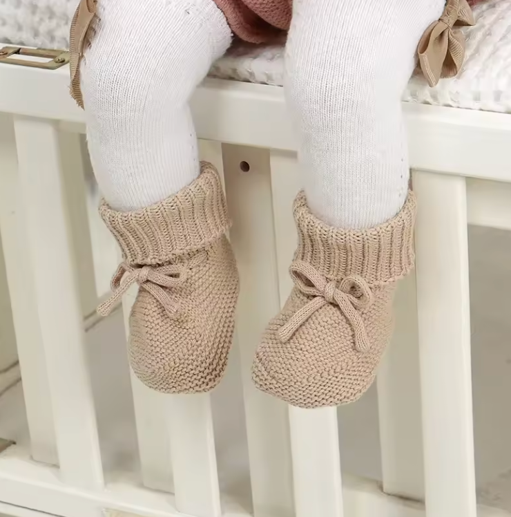 Warm baby shoes made from cotton wool blend, featuring a comfortable knitted design for infants.