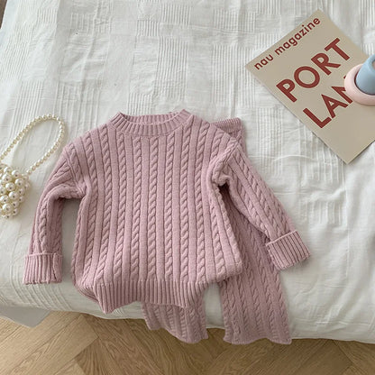 Toddler girl in a cute knitted sweater and pant set, ideal for fall and winter wear.