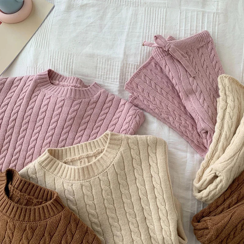 Close-up of the knitted texture on a girls' cozy fall winter sweater and pants set.