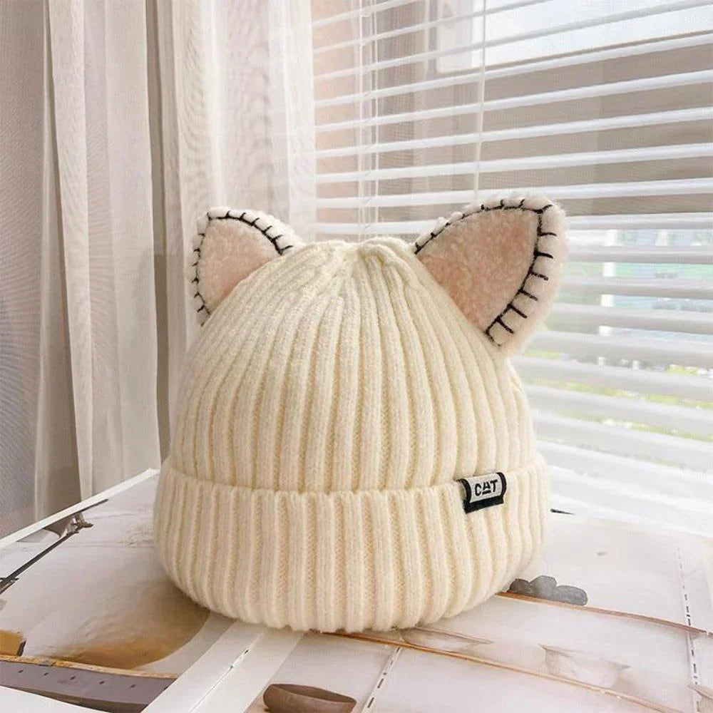 Cozy knitted women's winter hat with cute cat ears, perfect for cold weather fashion.