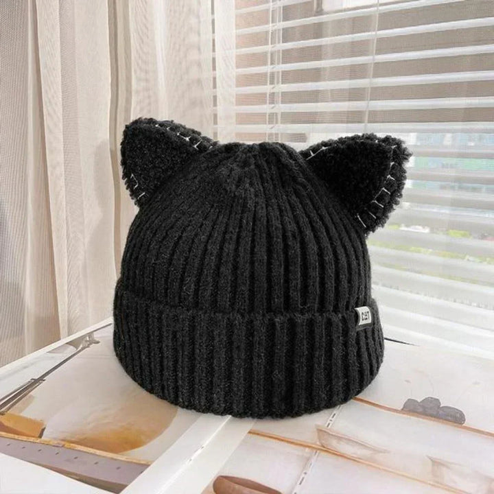Women's warm knitted winter hat featuring playful cat ears, a stylish cold weather accessory.
