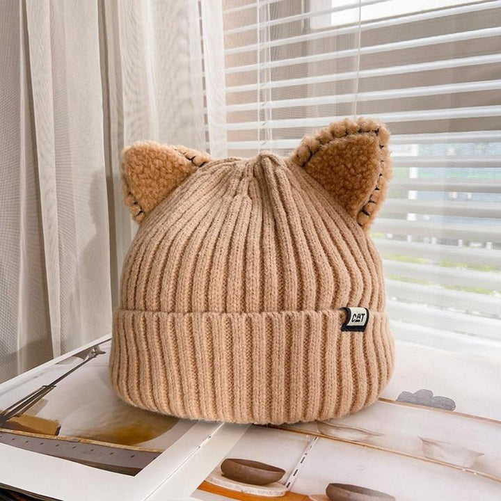 Stylish women's knitted hat with adorable cat ears, ideal for winter warmth and cute style.
