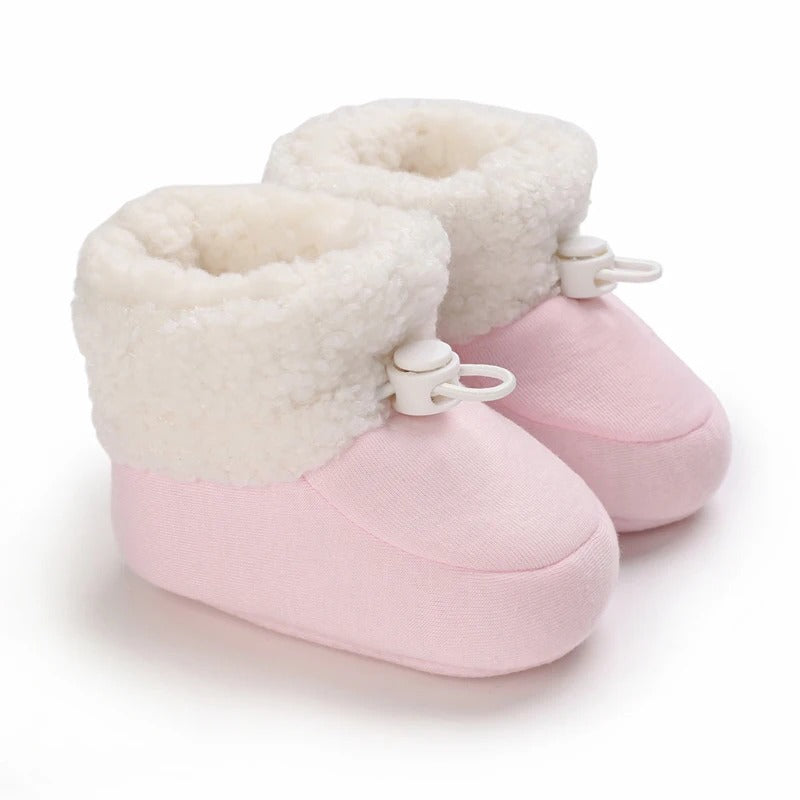 Adorable infant winter footwear, non-slip and warm for early walkers.