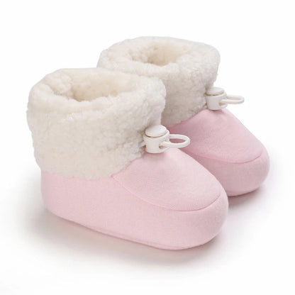 Adorable infant winter footwear, non-slip and warm for early walkers.