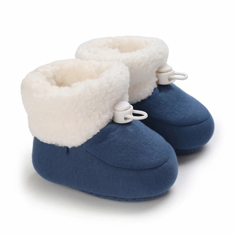 High-top baby boots with adjustable closure, providing a secure and warm fit.