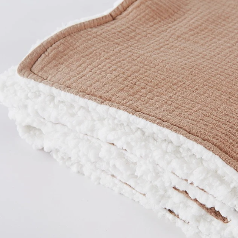 Close-up of cozy, thick, breathable baby swaddle blanket texture, perfect for newborns