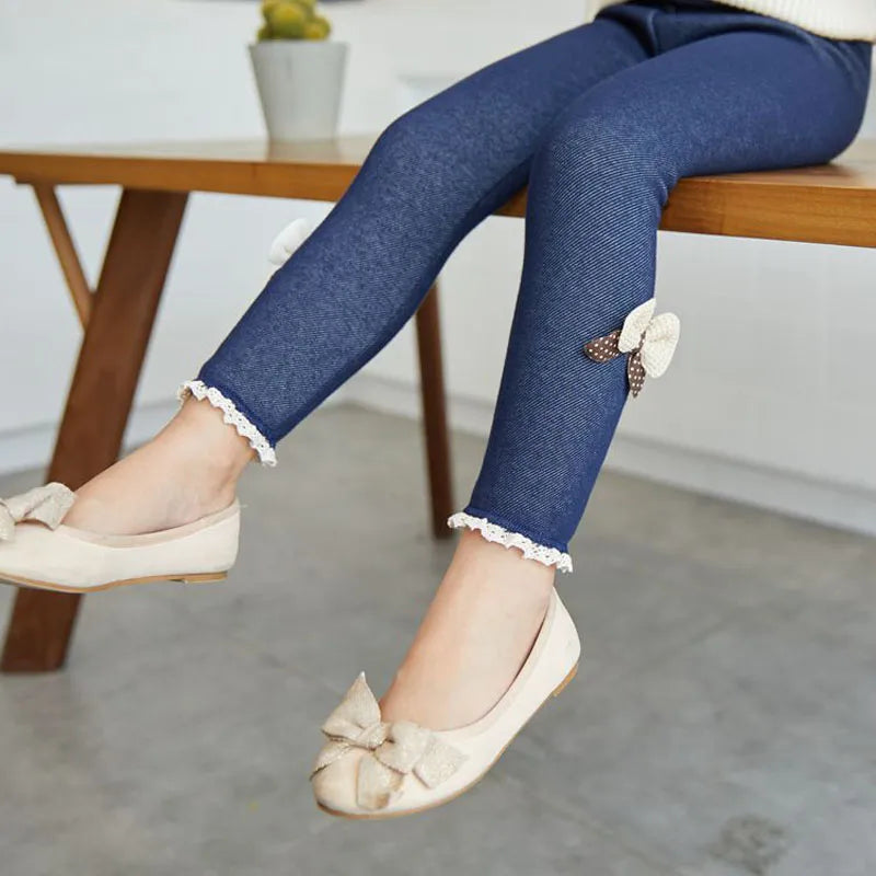 Pair of soft pink girls' leggings with elastic waist and cute bow embellishments