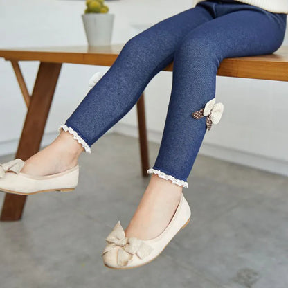 Pair of soft pink girls' leggings with elastic waist and cute bow embellishments