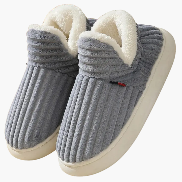Warm women's bootie slippers with a soft ribbed design for ultimate indoor comfort. Plush lounge house shoes.