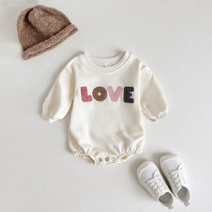 Cream baby romper with 'love' embroidery, comfortable cotton blend for newborns. Unisex infant clothing.