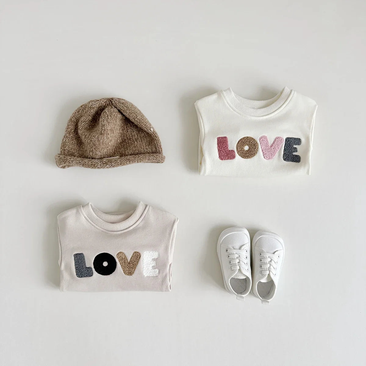 Back view of a khaki baby romper, emphasizing comfortable fit for active infants.