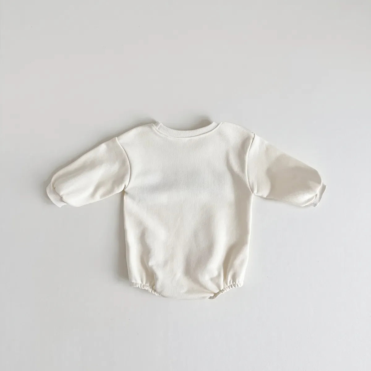 Unisex baby romper in cream color, 'love' embroidery on chest, perfect for newborn fashion.