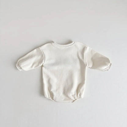 Unisex baby romper in cream color, 'love' embroidery on chest, perfect for newborn fashion.