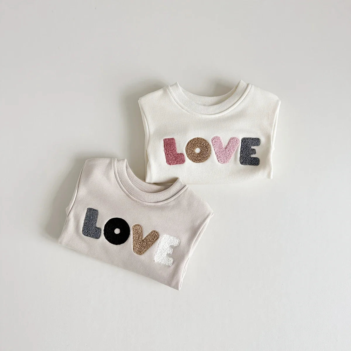 Baby boy wearing a khaki cotton blend romper with 'love' text, comfortable and stylish.