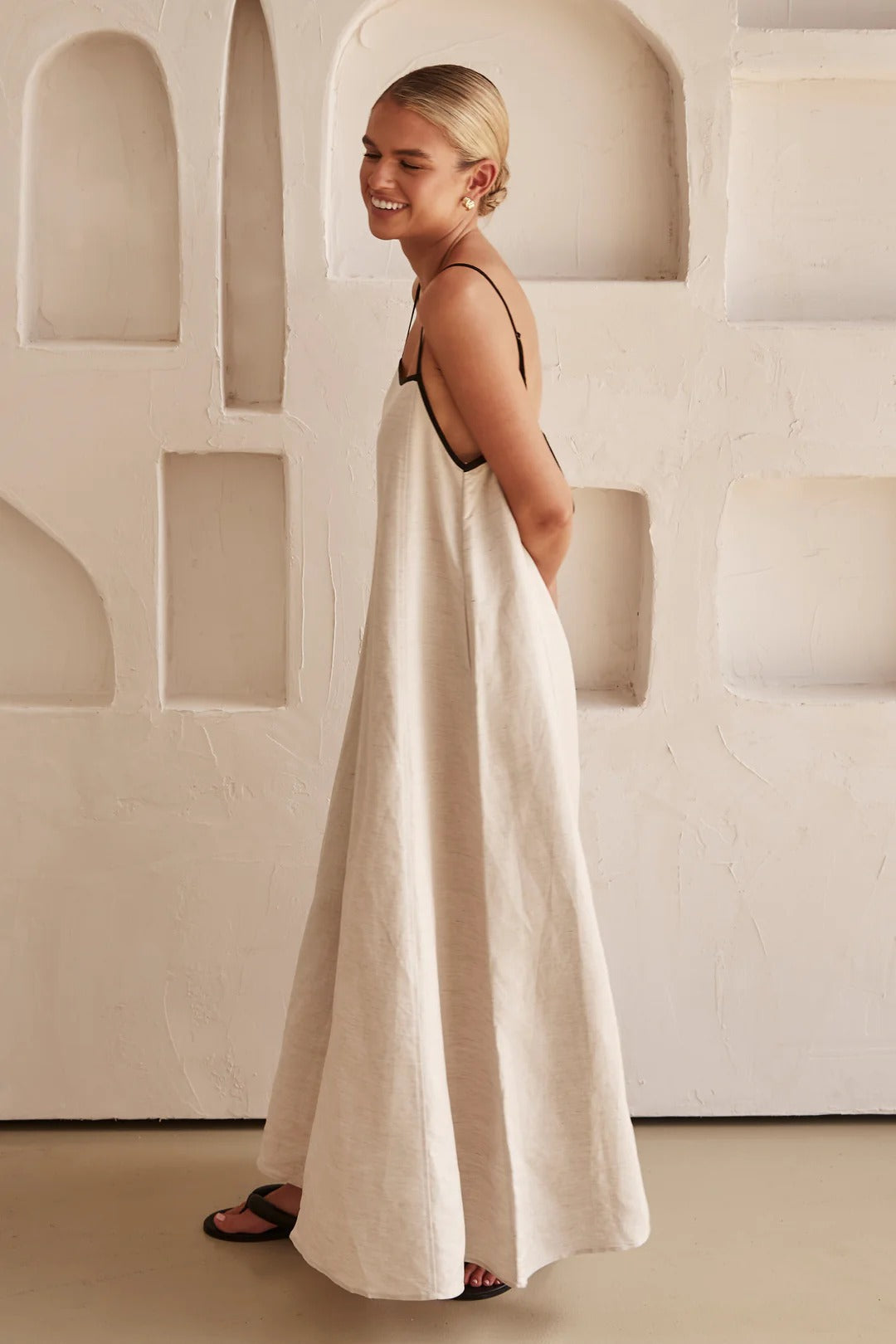 Chic cream maxi dress for women, square neck, spaghetti straps, with a stylish contrast trim detail.