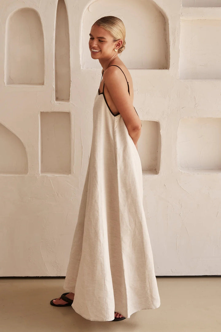 Chic cream maxi dress for women, square neck, spaghetti straps, with a stylish contrast trim detail.