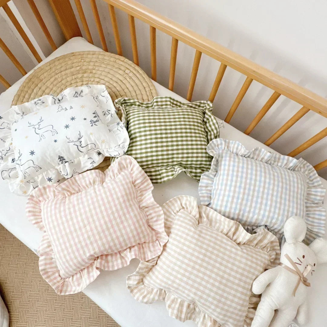 Close-up of customized baby pillow, 'Olivia' embroidered, delicate ruffle edge