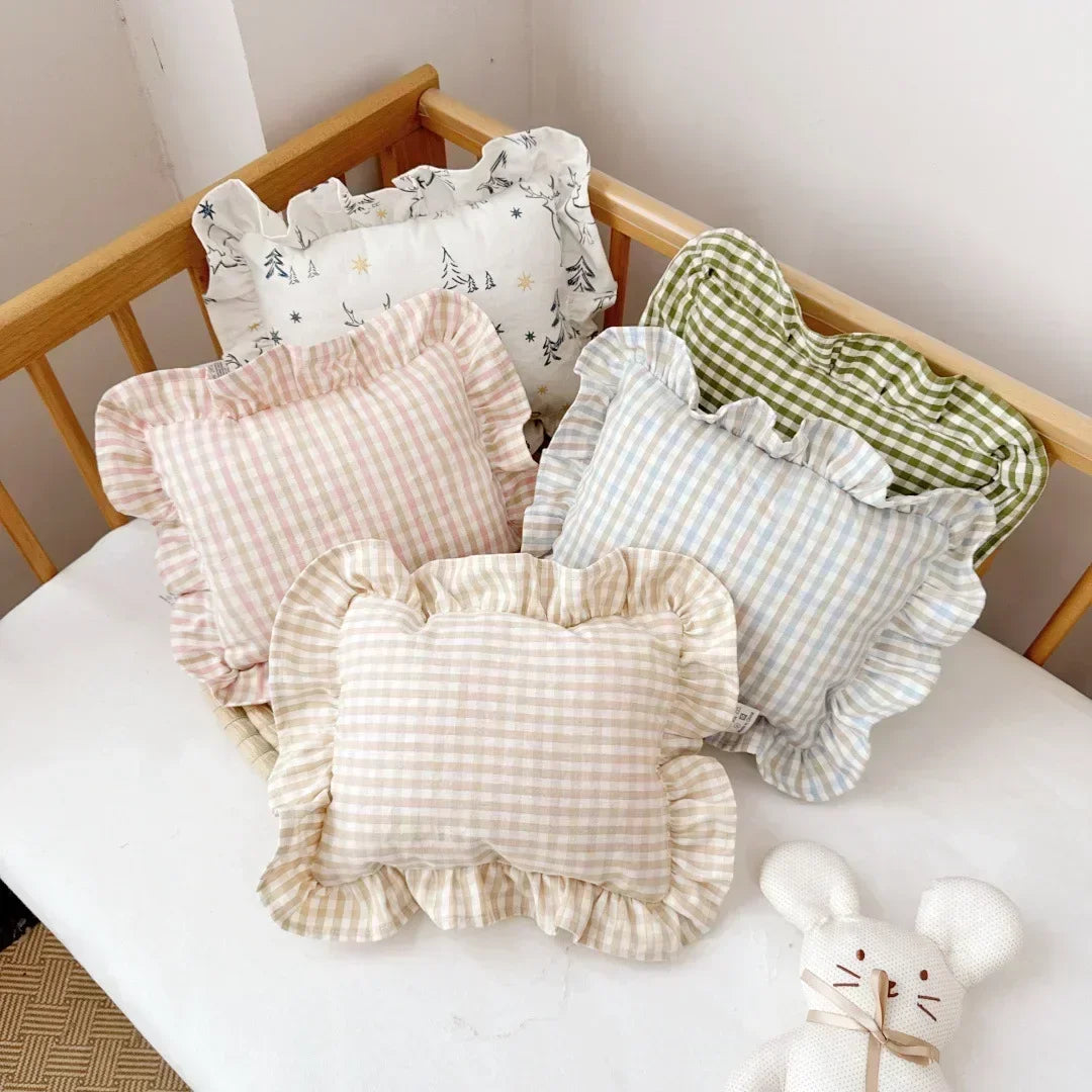 Soft white cotton baby name pillow with ruffles, ideal for nursery decor