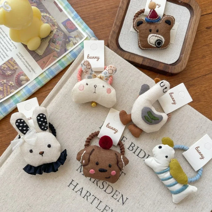 Adorable 10-pack girls' animal hair clips & bands with plush fabric designs.