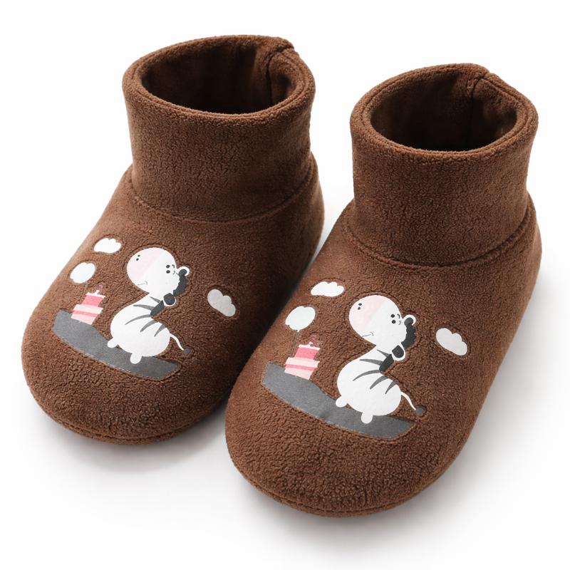 A pair of anti-slip plush winter socks for babies, ideal for keeping tiny feet warm and preventing slips.