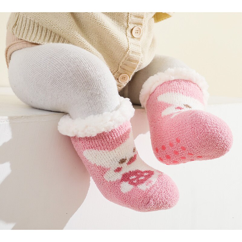 Adorable baby girl crawling, showcasing pink terry anti-slip socks for safe infant movement.