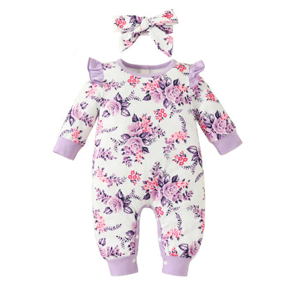 Cheerful baby girl wearing a vibrant floral romper and large bow headband, happy infant clothing.
