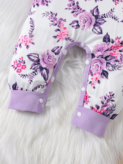 Detail of the matching bow headband from the baby girl's floral romper set, cute accessory.