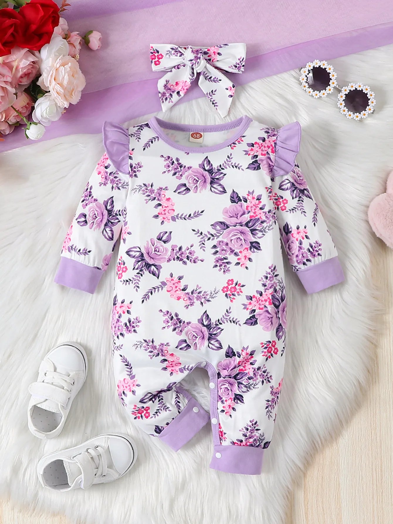 Newborn girl's outfit: long sleeve floral print romper and matching stretch bow headband.