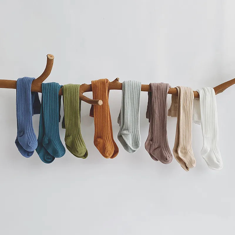 Cute baby girl in white cotton knit pantyhose, perfect for infants and toddlers, cozy and warm.