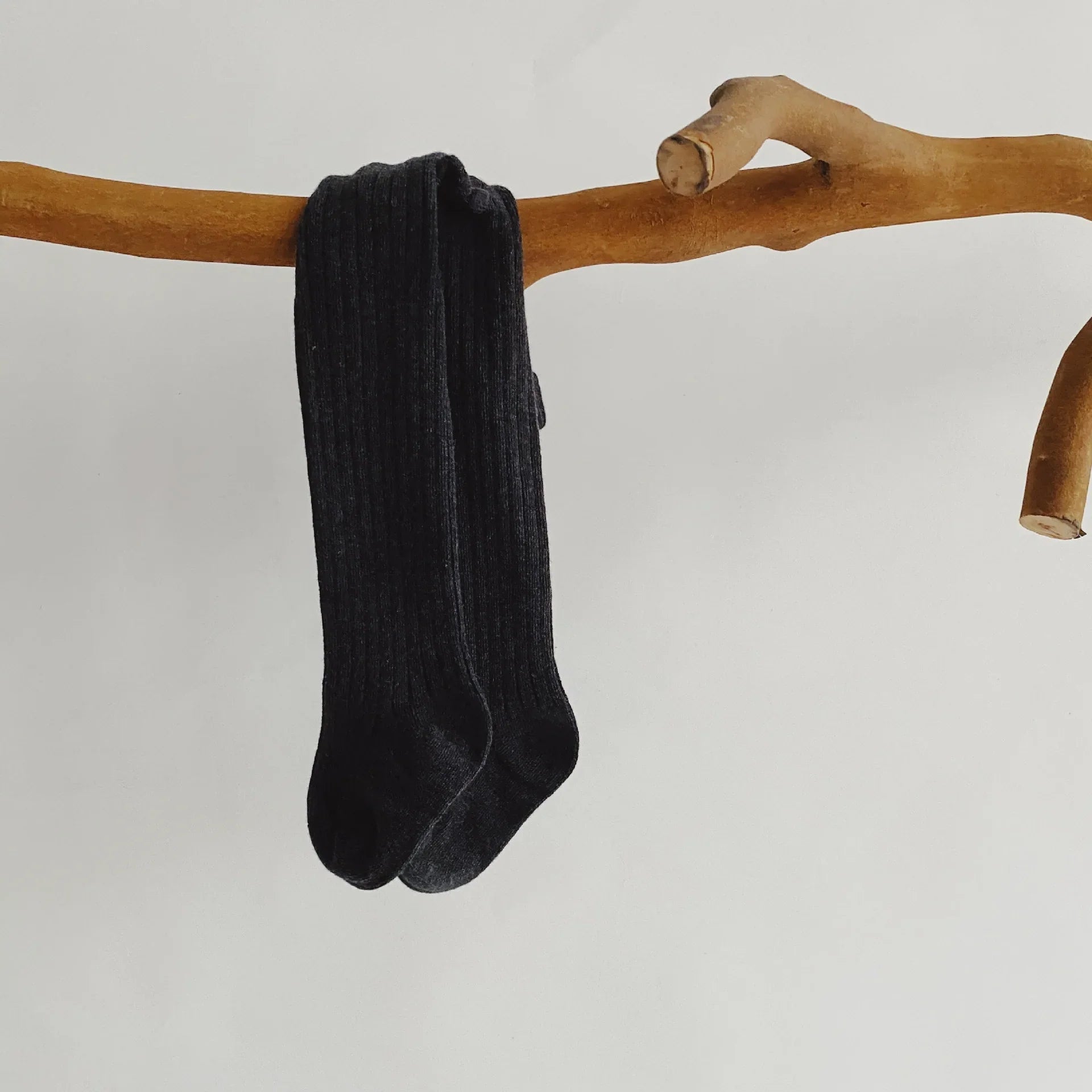Closeup of the elastic waistband on cotton knit pantyhose, ensuring a snug fit for baby girls.