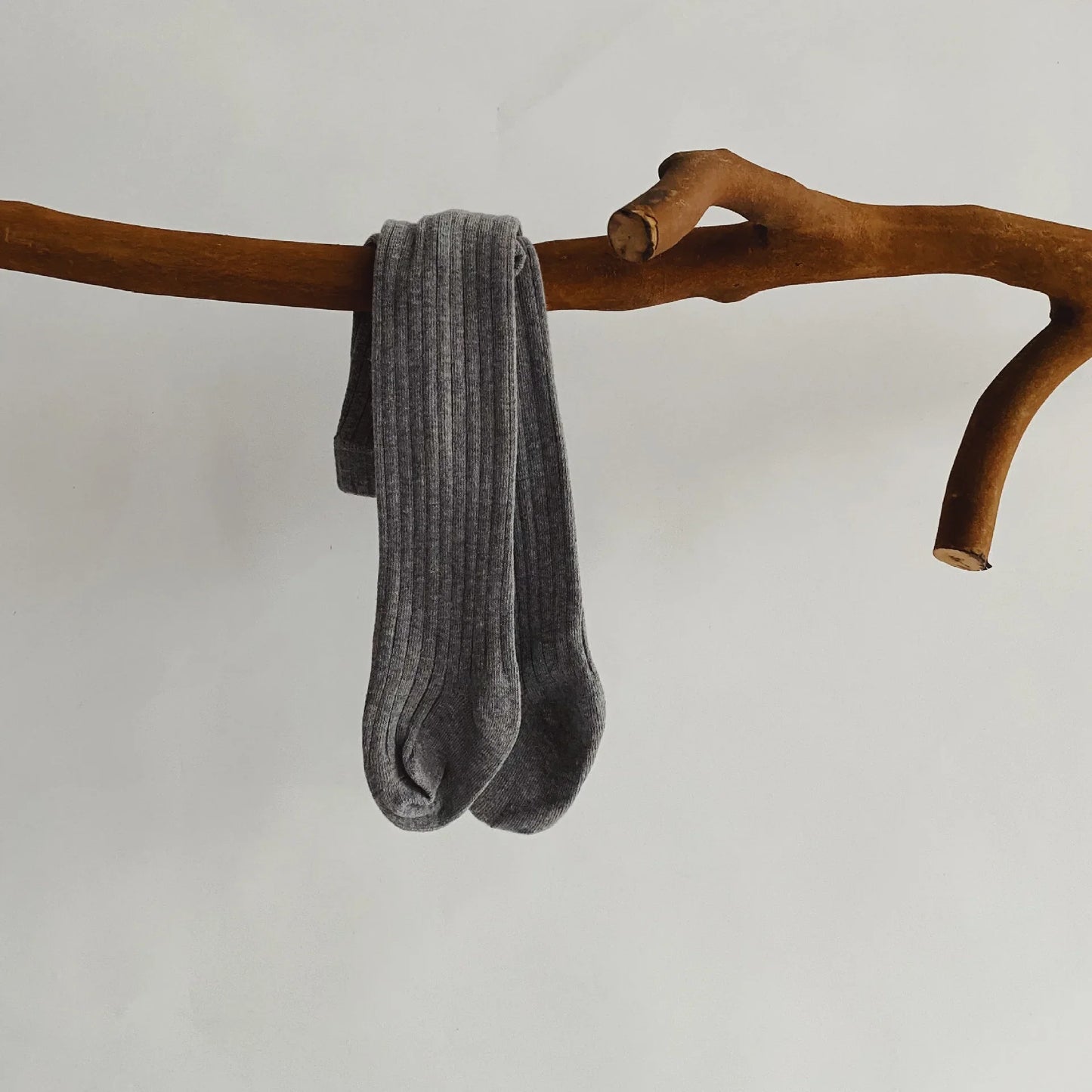 Baby girl's outfit featuring white cotton knit pantyhose, a staple in children's apparel.