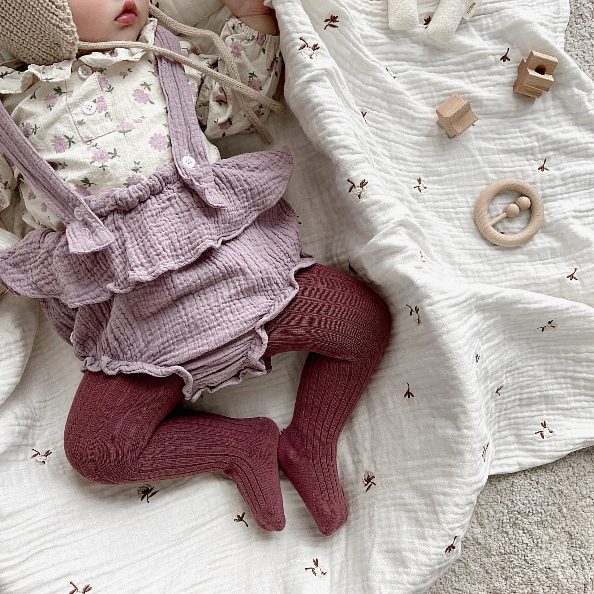 Adorable toddler girl wearing patterned cotton knit tights, cozy and stylish children's apparel.