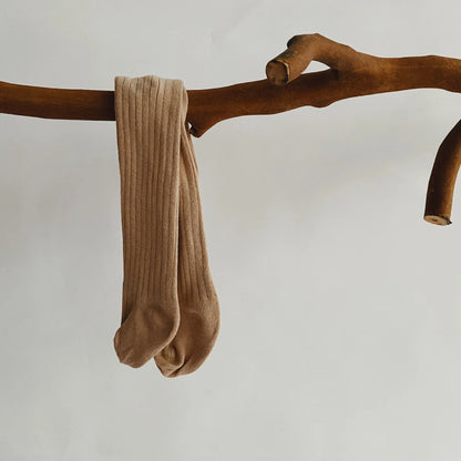 Toddler playing in soft purple cotton knit pantyhose, comfortable tights for everyday wear.