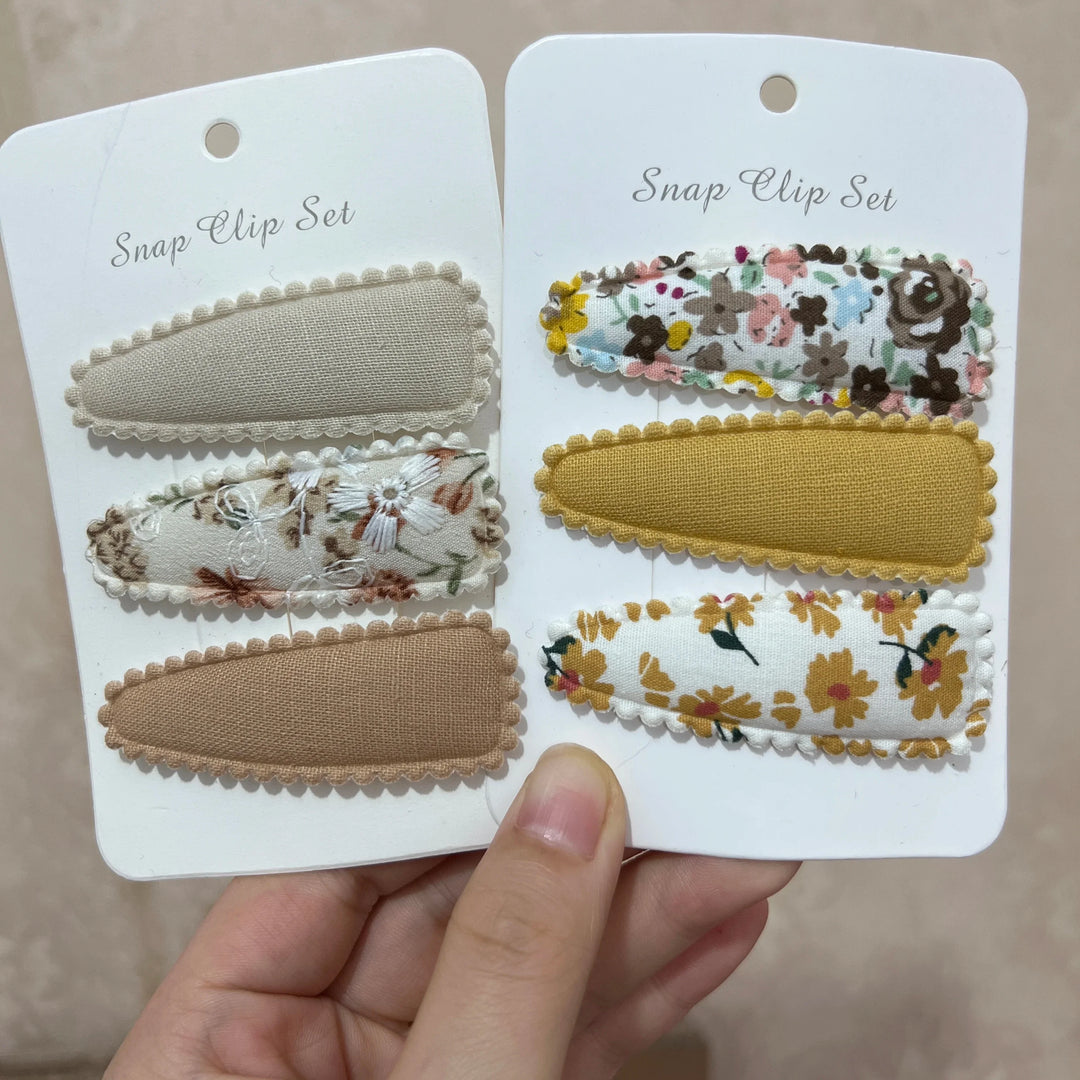 Floral print hair clips, a stylish children's accessory for baby girls. Perfect for infant & toddler fashion.