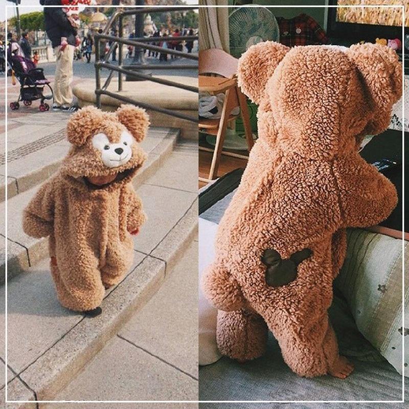 Cute baby in a soft beige polyester teddy bear hooded jumpsuit, perfect cozy winter outfit for infants.