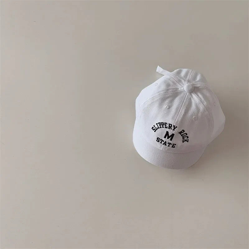 Infant wearing soft cotton embroidered baseball cap, perfect for casual baby accessories
