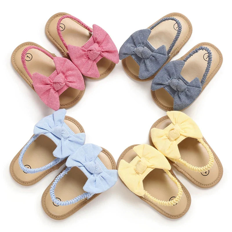 Adorable red infant cotton sandals with supportive cork sole, perfect for baby girls' first steps.