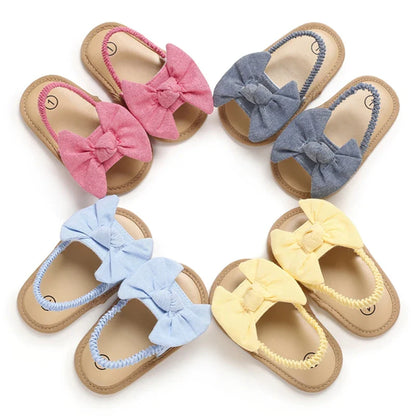 Adorable red infant cotton sandals with supportive cork sole, perfect for baby girls' first steps.