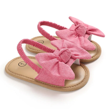 Pair of colorful baby sandals (red, blue, yellow) with soft cork soles, perfect for infant comfort shoes.